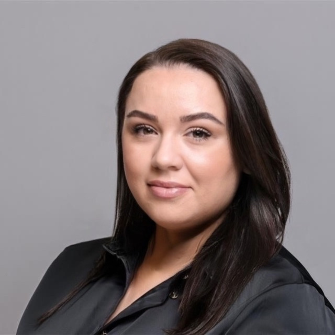 image of a female portrait smiling and wearing a black shirt.